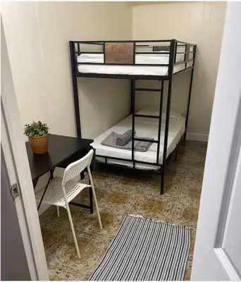 a room with two bunk beds and a table and a desk at Peach Private Room in Miami