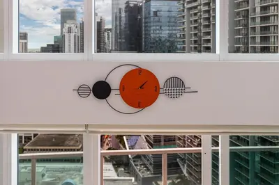a clock in a window with a view of a city at Brickell Miami LUXURY LOFT 2bd 2bth, Sleeps 6, Garage Parking, Walk to HOTTEST Restaurants & Nighlife in Miami