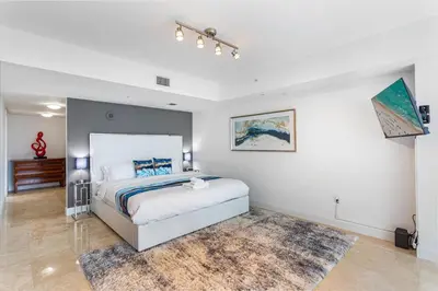 a bedroom with a large bed and a rug at Brickell Miami LUXURY LOFT 2bd 2bth, Sleeps 6, Garage Parking, Walk to HOTTEST Restaurants & Nighlife in Miami