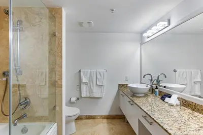 a white bathroom with two sinks and a shower at Brickell Miami LUXURY LOFT 2bd 2bth, Sleeps 6, Garage Parking, Walk to HOTTEST Restaurants & Nighlife in Miami