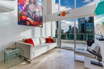 a living room with a white couch and large windows at Brickell Miami LUXURY LOFT 2bd 2bth, Sleeps 6, Garage Parking, Walk to HOTTEST Restaurants & Nighlife in Miami