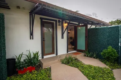 a house with a green wall and a patio at Sunset in Sunset