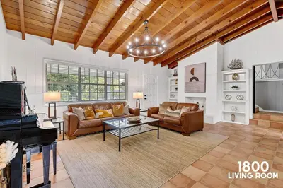 a living room with a couch and a piano at 3 Home 12 bedroom compound with Pool and BBQ sleeps 24 in Miami