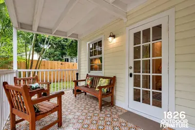 a porch with two chairs and a door at 3 Home 12 bedroom compound with Pool and BBQ sleeps 24 in Miami