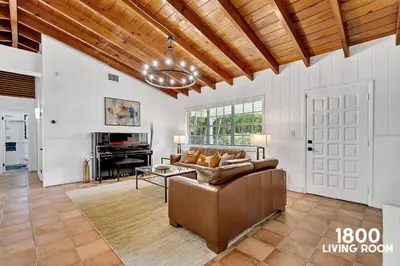 a living room with a couch and a table at 3 Home 12 bedroom compound with Pool and BBQ sleeps 24 in Miami