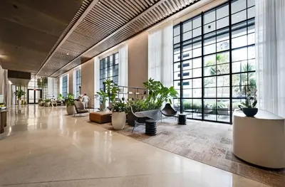 a lobby with potted plants and large windows at Modern Downtown Studio with city views in Miami