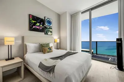 a bedroom with a large bed and a large window at Penthouse Vacation Beach Resort in Hollywood