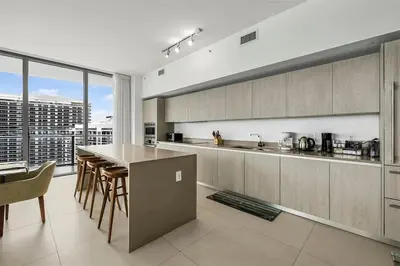 a kitchen with a table and chairs and a large window at Penthouse Vacation Beach Resort in Hollywood