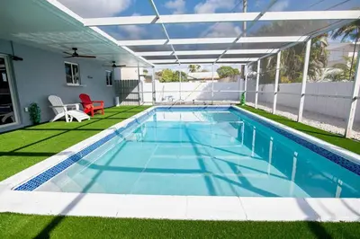 a swimming pool with a pergola on a house at Luxury Retreat Near Hard Rock in Joe Robbie Stadium Heliport