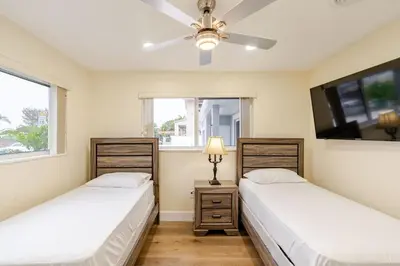 two beds in a room with two windows at Luxury Retreat Near Hard Rock in Joe Robbie Stadium Heliport