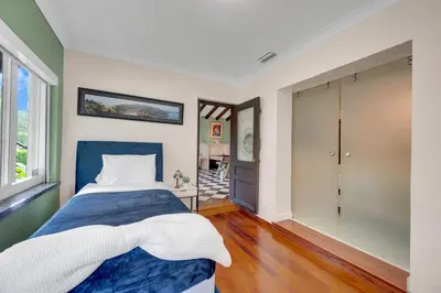 a bedroom with a blue and white bed and a window at Magnificent Tropical Pool Home Miami SouthBrickell in Miami