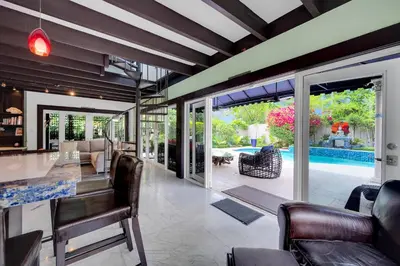an open living room with a table and chairs at Magnificent Tropical Pool Home Miami SouthBrickell in Miami