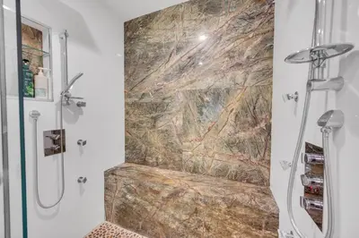 a shower in a bathroom with a marble wall at Magnificent Tropical Pool Home Miami SouthBrickell in Miami