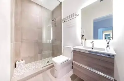 a bathroom with a toilet and a sink and a shower at Modern Brickell Luxe Apartment by Palermo Home Miami in Miami