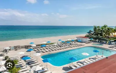 an aerial view of a resort with a swimming pool and the beach at Ocean front paradise studio with ocean view and beach exit in Sunny Isles Beach