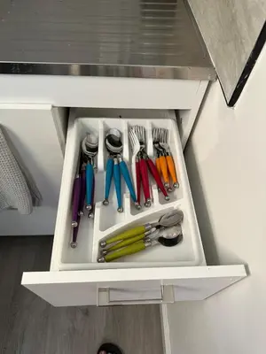 a drawer filled with utensils in a cabinet at 2 Nice and Cozy guest house in Opa-locka