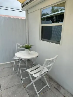 two chairs and a table on a patio at 2 Nice and Cozy guest house in Opa-locka
