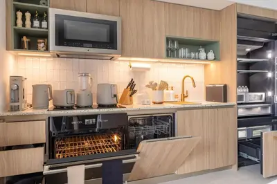 a kitchen with an oven with a tv above it at 3701 Kaseya Center 2 Bdr Apt with Pool and Gym in Miami