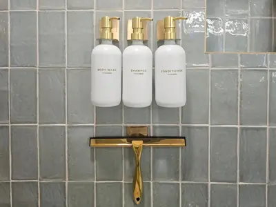 three bottles on a wall with a pair of scissors at 3005 golden305 2BR Apt mins to Wynwood and Brickell w Pool a Gym and PS5 in Miami