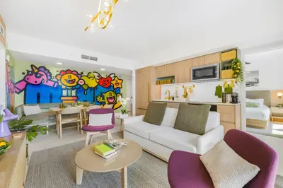 a living room with a white couch and purple chairs at 3005 golden305 2BR Apt mins to Wynwood and Brickell w Pool a Gym and PS5 in Miami