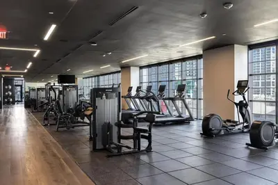 a gym with treadmills and ellipticals in a building at 4305 High Floor Apt with City and Marina Views in Miami