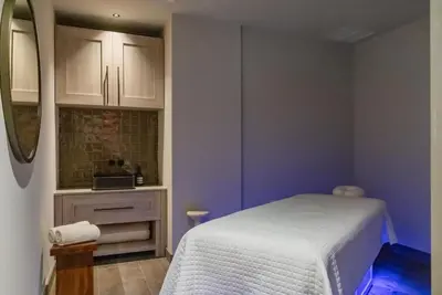 a small bedroom with a white bed and purple walls at 4305 High Floor Apt with City and Marina Views in Miami