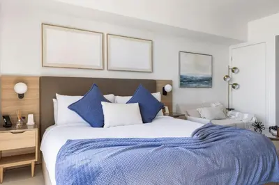 a bedroom with a large bed with blue and white pillows at 3012 Studio in front of Kaseya Center with Pool in Miami