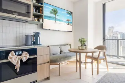 a kitchen and dining room with a table and a couch at 3012 Studio in front of Kaseya Center with Pool in Miami