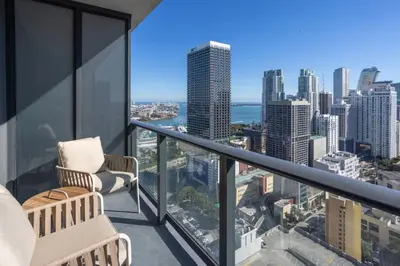 a balcony with two chairs and a view of the city at 3012 Studio in front of Kaseya Center with Pool in Miami