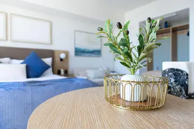a vase with flowers on a table in a room at 3012 Studio in front of Kaseya Center with Pool in Miami