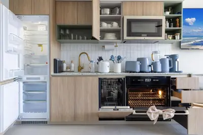 a kitchen with an oven with a microwave and a refrigerator at 3012 Studio in front of Kaseya Center with Pool in Miami