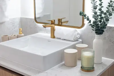 a bathroom sink with a gold faucet and a mirror at 3209 Apt in Heart of Downtown with Pool a Gym and Spa in Miami