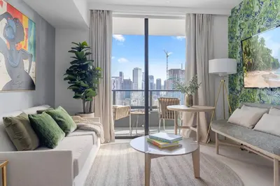 a living room with a couch and a large window at 2414 Chic Stay in Miami Downtown with Bay and City Views a Pool and Gym in Miami
