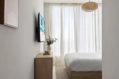 a bedroom with a bed and a tv and a window at 3615 Luxury Condo for 8 people with Gym and Pool in front of Kaseya Center in Miami