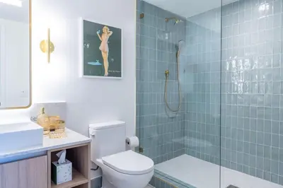 a bathroom with a toilet and a glass shower at 3615 Luxury Condo for 8 people with Gym and Pool in front of Kaseya Center in Miami