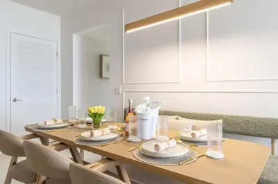 a dining room table with plates on it with chairs at 3615 Luxury Condo for 8 people with Gym and Pool in front of Kaseya Center in Miami