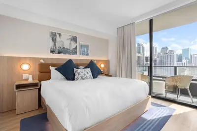 a bedroom with a large bed and a large window at 2012 New Apt with Pool and Gym in front of Kaseya Center in Miami