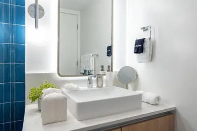 a bathroom with a white sink and a mirror at 2012 New Apt with Pool and Gym in front of Kaseya Center in Miami
