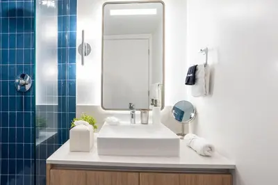 a bathroom with a white sink and a mirror at 2012 New Apt with Pool and Gym in front of Kaseya Center in Miami
