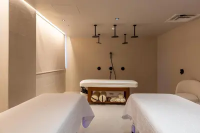 two beds in a room with a table and a sink at 3001 Miami Downtown Apt with Gym and Pool next to Kaseya Center in Miami
