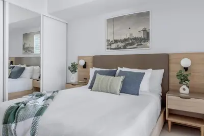 a bedroom with two beds and a mirror at 3001 Miami Downtown Apt with Gym and Pool next to Kaseya Center in Miami