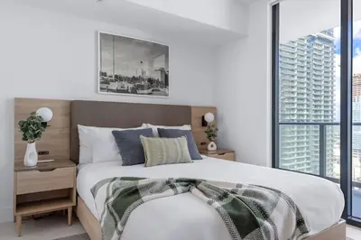 a bedroom with a large bed and a large window at 3001 Miami Downtown Apt with Gym and Pool next to Kaseya Center in Miami