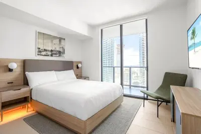 a bedroom with a bed and a desk and a chair at 2901 Beautiful Downtown Apt with Pool and Gym in Miami