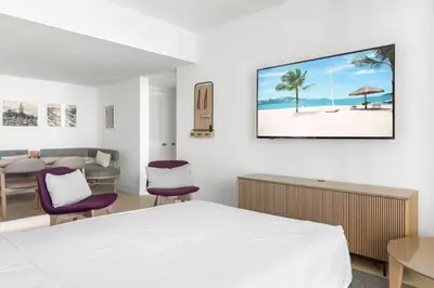 a hotel room with a bed and a table and chairs at 2901 Beautiful Downtown Apt with Pool and Gym in Miami