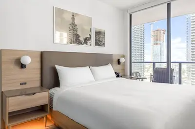a bedroom with a large bed and a large window at 2901 Beautiful Downtown Apt with Pool and Gym in Miami