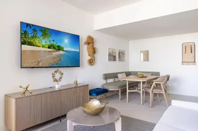 a living room with a table and a tv on the wall at 2409 Apt in Downtown Miami with Gym and in front of Kaseya Center in Miami