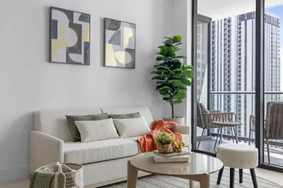 a living room with a couch and a table at 2704 Beautiful Downtown Apt with Gym Pool Spa Skyline Views and in front of Kaseya Center in Miami