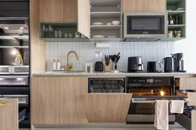 a kitchen with a stove and a microwave at 2704 Beautiful Downtown Apt with Gym Pool Spa Skyline Views and in front of Kaseya Center in Miami