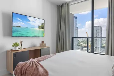 a bedroom with a bed and a large window at 2704 Beautiful Downtown Apt with Gym Pool Spa Skyline Views and in front of Kaseya Center in Miami
