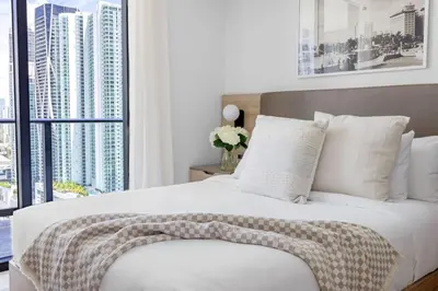a bedroom with a bed with white pillows and a window at 3002 Downtown Miami apt in front of Kaseya Center with Gym and Pool in Miami